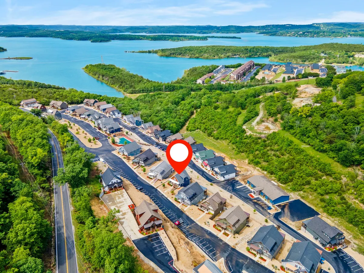 A scenic exterior view that overlooks Table Rock Lake, with newly constructed homes dotting the landscape among winding roads and greenery. The serene setting invites exploration, relaxation, and connection to Branson's remarkable surroundings.